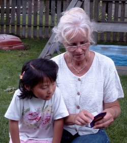 Lene showing Yanmei the bracelet Anik gave to her