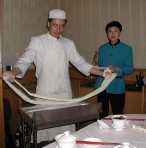 Scenes from a Chinese restaurant- making noodles.