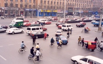 A busy street corner - the cars have the right to turn right into traffic