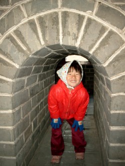 Yanmei under an arch in one of the buildings on the way up