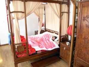 Yanmei trying out the four poster bed