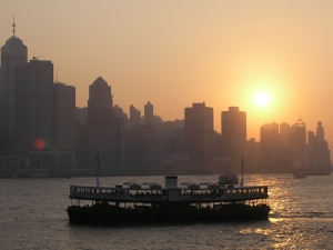The Star Ferry sailing towards Hong Kong at sunset